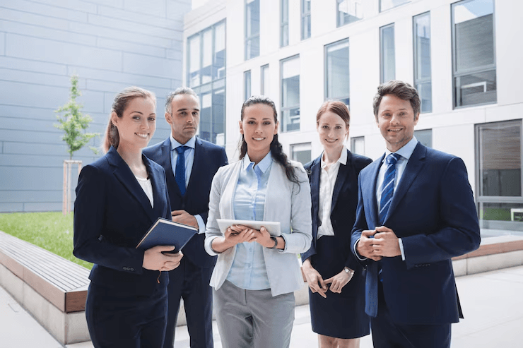 A diverse team of five business professionals in modern office environment